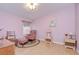 Cozy bedroom featuring natural light, comfortable seating, and a peaceful ambiance at 37642 Landis Ave, Zephyrhills, FL 33541