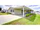 A charming single Gathering home boasting a covered parking area and verdant landscaping at 37642 Landis Ave, Zephyrhills, FL 33541