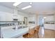 Kitchen boasts a spacious island with seating, ample cabinets, and appliances at 37642 Landis Ave, Zephyrhills, FL 33541
