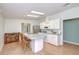 Cozy kitchen with island, light cabinets, and a connected dining area at 37642 Landis Ave, Zephyrhills, FL 33541