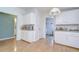 Bright kitchen with white cabinets, wood flooring and a view to the laundry room for added convenience at 37642 Landis Ave, Zephyrhills, FL 33541