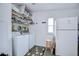Functional laundry room with washer, dryer, refrigerator, shelving and storage; convenient and efficient design at 37642 Landis Ave, Zephyrhills, FL 33541