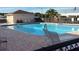 Relaxing community pool with inviting lounge chairs and well-maintained brick surround at 37642 Landis Ave, Zephyrhills, FL 33541