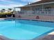 Sparkling outdoor pool with stairs and a railing for easy access, set in a relaxing community at 37642 Landis Ave, Zephyrhills, FL 33541