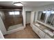 Renovated bathroom features dual sinks, a shower-tub combo, and granite countertops at 37913 Wicklow Ave, Zephyrhills, FL 33541