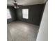Bedroom showcasing neutral paint, tile floors, two windows and a ceiling fan at 37913 Wicklow Ave, Zephyrhills, FL 33541