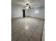 Bedroom with tile floors features a ceiling fan and natural lighting from exterior window at 37913 Wicklow Ave, Zephyrhills, FL 33541