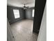 Bedroom featuring neutral paint, tile floors, a ceiling fan and natural light at 37913 Wicklow Ave, Zephyrhills, FL 33541