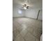 Bedroom with tile floors features a ceiling fan and exterior door for additional access at 37913 Wicklow Ave, Zephyrhills, FL 33541