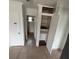 Hallway features built-in storage, neutral tile flooring and leads to the bathroom at 37913 Wicklow Ave, Zephyrhills, FL 33541