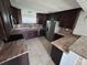 Modern kitchen with dark wood cabinets, granite countertops, and stainless steel appliances at 37913 Wicklow Ave, Zephyrhills, FL 33541