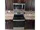 This updated kitchen features stainless steel appliances and tile backsplash for easy cleanup at 37913 Wicklow Ave, Zephyrhills, FL 33541