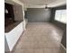 Spacious living area featuring tile flooring and opening to a breakfast bar at 37913 Wicklow Ave, Zephyrhills, FL 33541