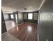 Spacious living room with hardwood floors, built-in shelving, and abundant natural light at 37913 Wicklow Ave, Zephyrhills, FL 33541