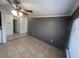 Living room boasts a ceiling fan, neutral paint, tile floors, and natural light at 37913 Wicklow Ave, Zephyrhills, FL 33541