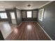 Spacious living room with hardwood floors, built-in shelving, and ample natural light at 37913 Wicklow Ave, Zephyrhills, FL 33541
