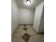Empty room featuring neutral paint, tile flooring with in-laid accent tiles, and recessed lighting at 37913 Wicklow Ave, Zephyrhills, FL 33541