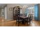 Traditional dining room featuring a wooden table, chandelier and display cabinet at 4311 W Beach Park Dr, Tampa, FL 33609