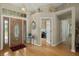 Elegant foyer with hardwood floors, a decorative light fixture, and a beautiful stained-glass front door at 4311 W Beach Park Dr, Tampa, FL 33609