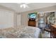 Cozy bedroom featuring neutral tones, television, and a sliding glass door leading to the exterior at 4694 Huron Rd, St Petersburg, FL 33708