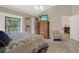 Serene bedroom with a comfortable bed, balcony access, and stylish decor at 4694 Huron Rd, St Petersburg, FL 33708