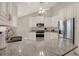 Modern kitchen featuring stainless steel appliances, granite countertops, and white cabinetry at 4694 Huron Rd, St Petersburg, FL 33708