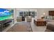 Comfortable living area with sliding glass doors, neutral decor, and ample seating at 4694 Huron Rd, St Petersburg, FL 33708