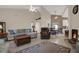 Spacious living room featuring a fireplace, ceiling fans, and a view into the dining area at 4694 Huron Rd, St Petersburg, FL 33708