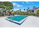Community pool surrounded by lush landscaping and plenty of lounge chairs, ideal for relaxation at 4694 Huron Rd, St Petersburg, FL 33708