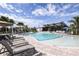 Stunning community pool with a modern clubhouse, ample seating, and lush landscaping under a sunny sky at 5012 124Th E Ave, Parrish, FL 34219