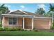 Charming single-story home featuring a blend of stone and stucco accents, and a well-manicured lawn at 5012 124Th E Ave, Parrish, FL 34219