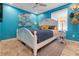 Cozy bedroom with bright blue walls, white furniture, and wood-look tile at 5012 Starfish Se Dr # B, St Petersburg, FL 33705