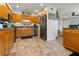 Functional kitchen boasts stainless steel appliances, warm wood cabinets, and tile flooring at 5012 Starfish Se Dr # B, St Petersburg, FL 33705
