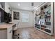 Office area with guitars, desk, shelving, and wood-look tile at 5012 Starfish Se Dr # B, St Petersburg, FL 33705