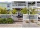 Charming patio with white picket fence, lush landscaping, and comfortable outdoor seating area at 5012 Starfish Se Dr # B, St Petersburg, FL 33705