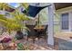 Relaxing outdoor patio with a dining area, lush landscaping, and a shade providing umbrella at 5012 Starfish Se Dr # B, St Petersburg, FL 33705