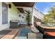 Inviting outdoor patio features comfortable seating area, lush landscaping, and stairs to the deck at 5012 Starfish Se Dr # B, St Petersburg, FL 33705