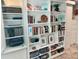 Built in shelving unit with decorations, books, storage containers, and printer at 5012 Starfish Se Dr # B, St Petersburg, FL 33705
