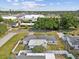 A bird's-eye view of a home featuring a well-maintained yard, complemented by mature trees and a neighborhood setting at 5812 52Nd N Ave, Kenneth City, FL 33709