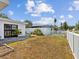 A well-maintained backyard with a white picket fence and a tidy patch of grass at 5812 52Nd N Ave, Kenneth City, FL 33709