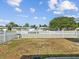 A well-maintained backyard with a white picket fence that enhances the home's appeal and defines the property lines at 5812 52Nd N Ave, Kenneth City, FL 33709
