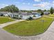 A charming single-story home boasts a well-manicured lawn and a welcoming curb appeal in a serene neighborhood at 5812 52Nd N Ave, Kenneth City, FL 33709