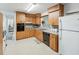Functional kitchen features light wood cabinetry, neutral countertops and a bright window view at 5812 52Nd N Ave, Kenneth City, FL 33709