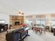 Cozy living room with a stone fireplace, ceiling fan, and comfortable seating at 5812 52Nd N Ave, Kenneth City, FL 33709
