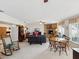 Open-concept living space with stone fireplace, comfortable seating, and natural light at 5812 52Nd N Ave, Kenneth City, FL 33709