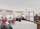 Expansive living room with a large window, ceiling fan, and stylish furnishings at 5812 52Nd N Ave, Kenneth City, FL 33709