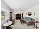 Spacious living room featuring a neutral color palette, large windows, and comfortable seating at 5812 52Nd N Ave, Kenneth City, FL 33709