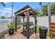 Outdoor grilling area with a grill and countertop under a wooden pergola at 6130 50Th N Ave, Kenneth City, FL 33709