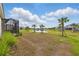 Landscaped backyard with pond and palm tree views at 6281 Dry Tortugas Dr, Sarasota, FL 34241