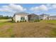 Backyard with sprinkler system, lush grass, and view of community at 6281 Dry Tortugas Dr, Sarasota, FL 34241